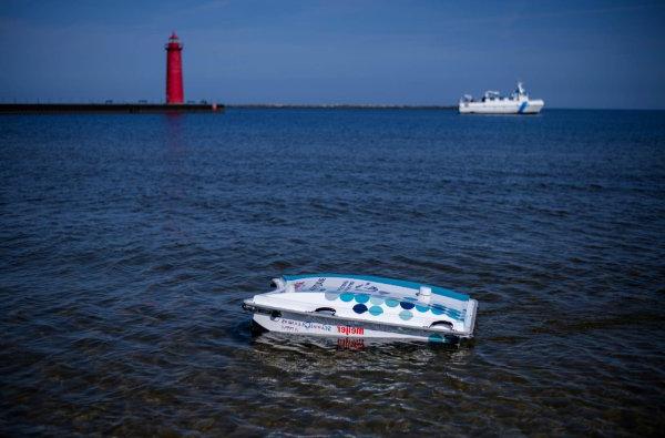 A drone floats on Lake Michigan collecting plastic and litter.