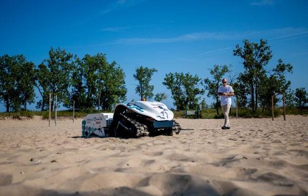 A drone combs a beach for plastic and litter.